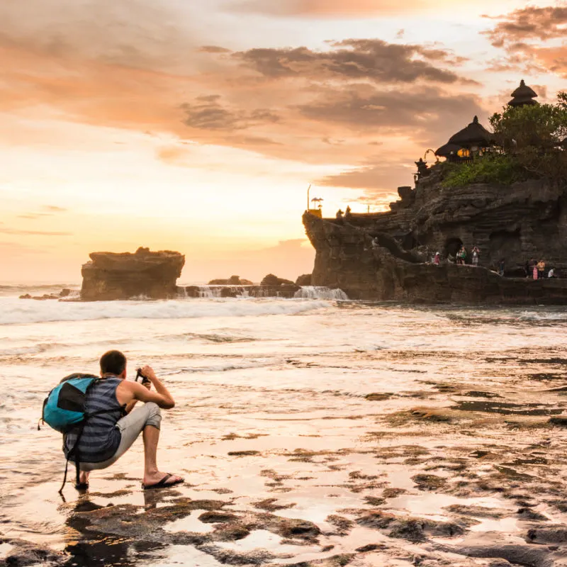 Photographer-Takes-Photo-Of-Tanah-Lot-Temple-In-Bali-At-Sunset