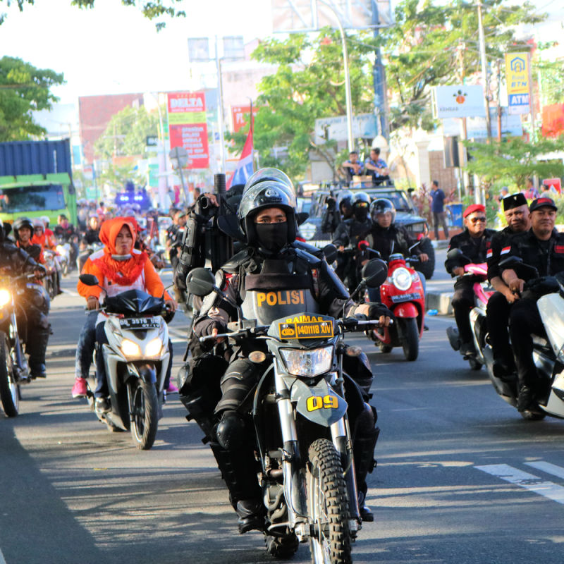 Police On A Motorbike Drives Through Busy Bali Streets