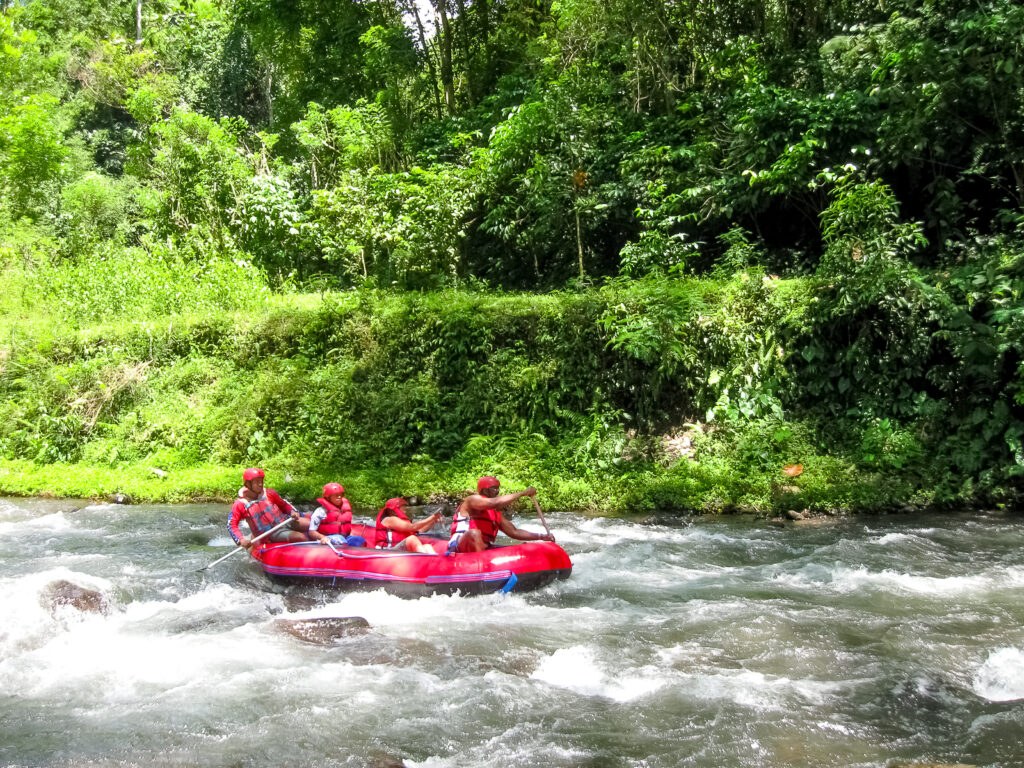 Red Raft Floats Down Ayung River In Bali.