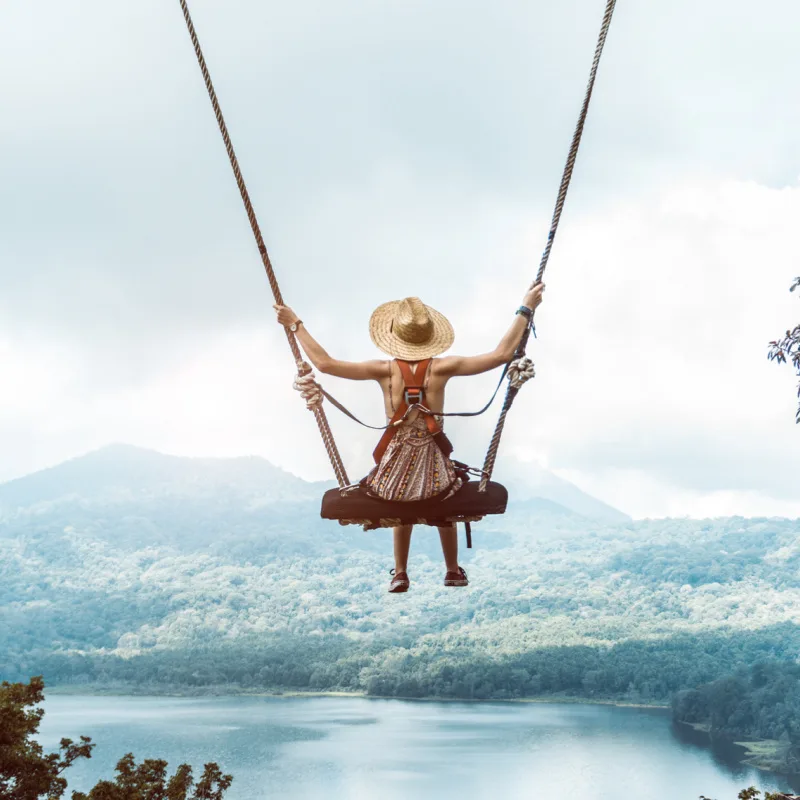 Tourist On A Swing Above Lake Batur In Bali