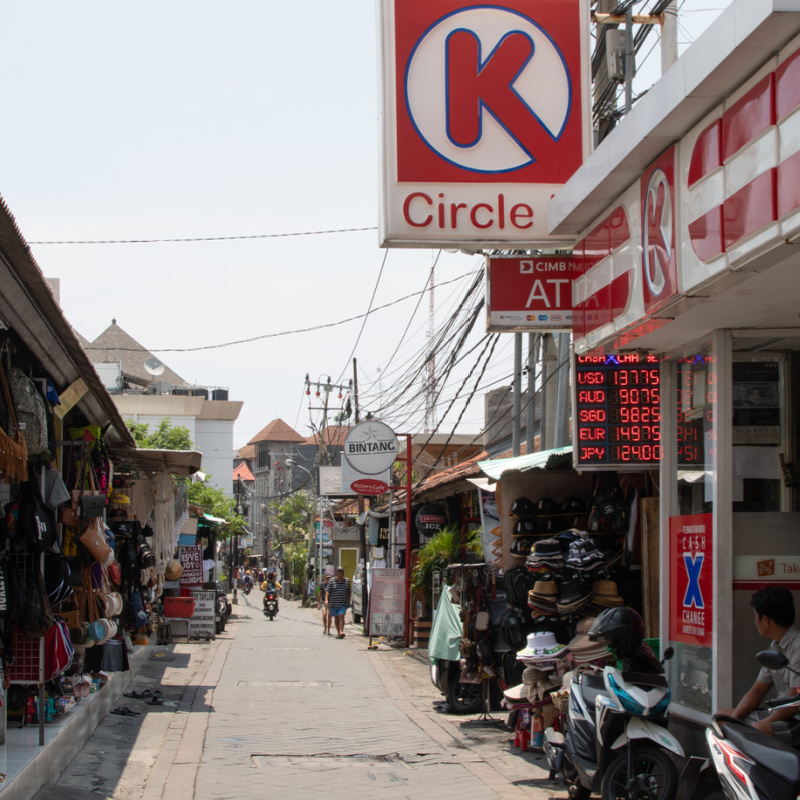 Tourist Shopping Street In Bali With Money Changing Shop and Circle k Supermarket