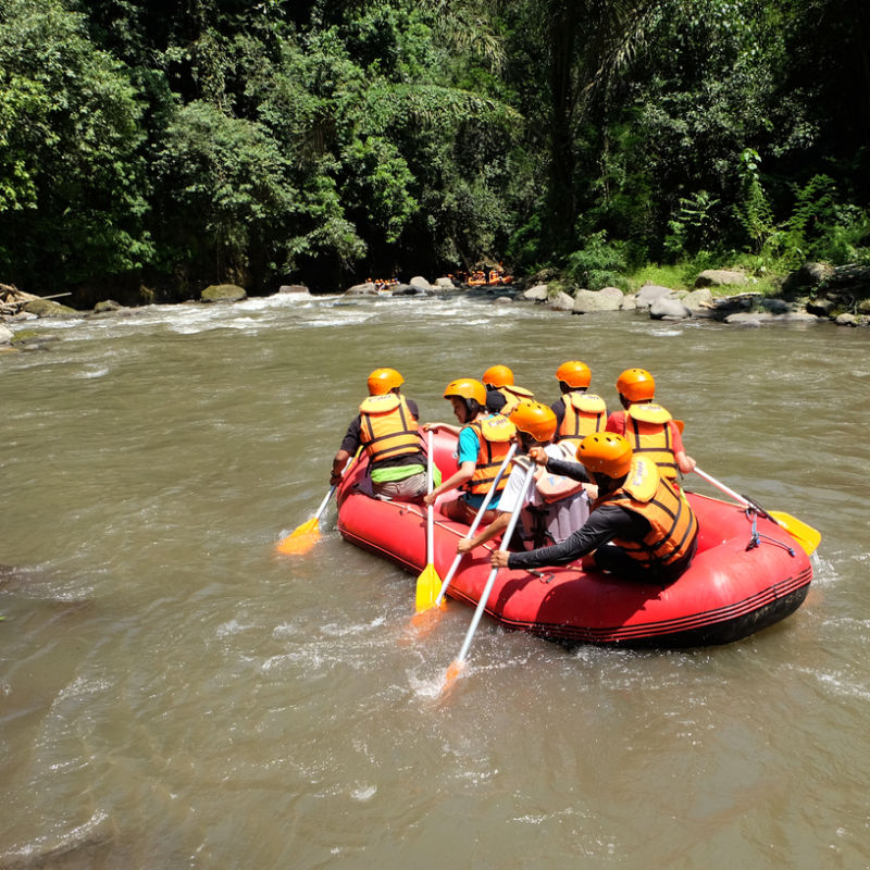 Tourists Rafting Downstream On Bali River