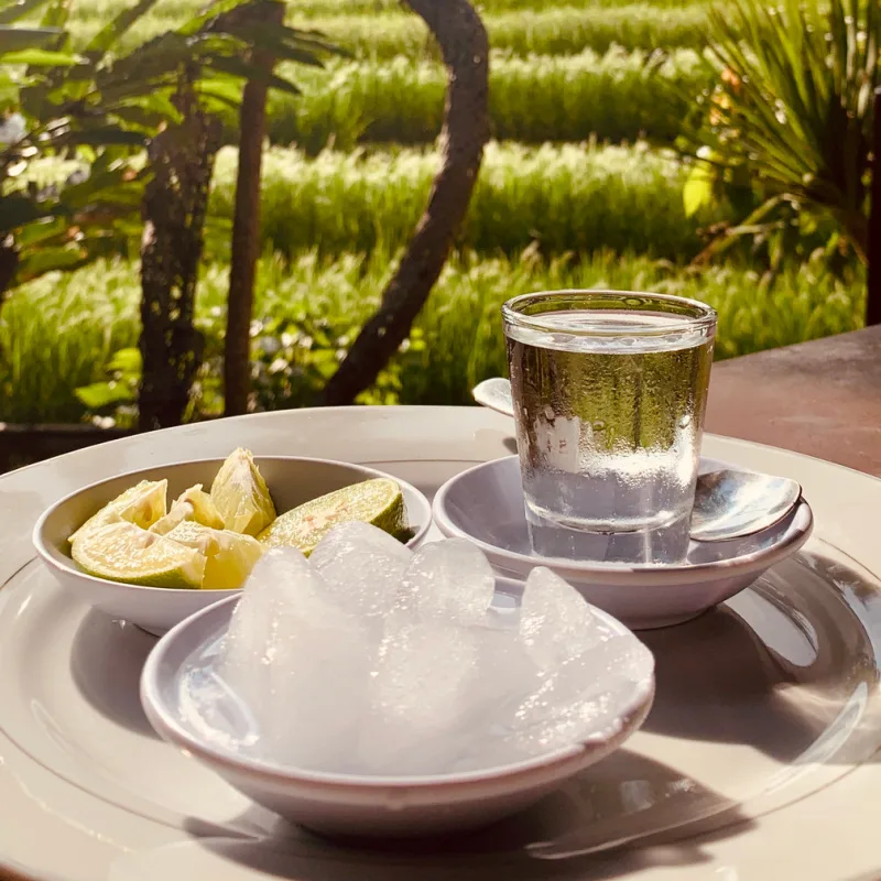 Traditional-Bali-Arak-In-A-Class-With-Ice-And-Lime-Overlooking-Rice-Field