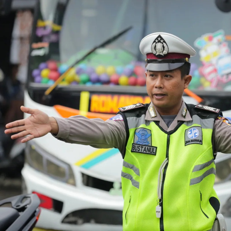 Traffic Officer In Bali Directs Drivers On The Road