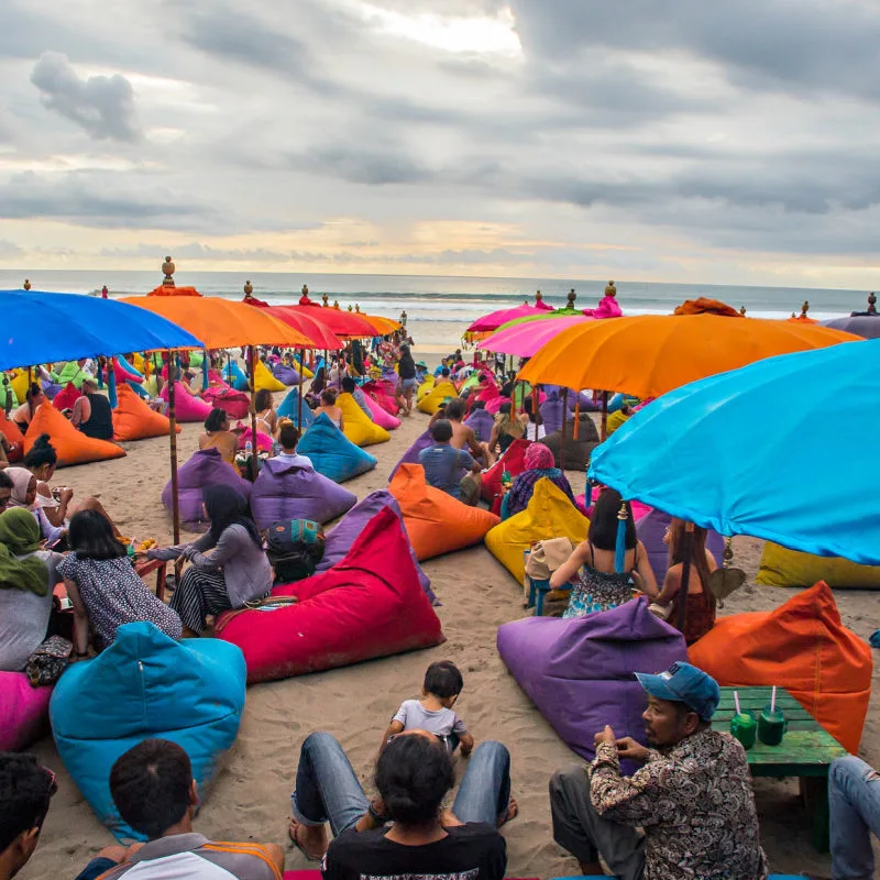 people on bean bags on a beach