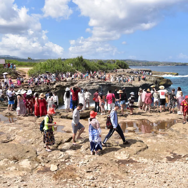 Chinese Tourists Stand At. Cliff Side In Bali.jpg