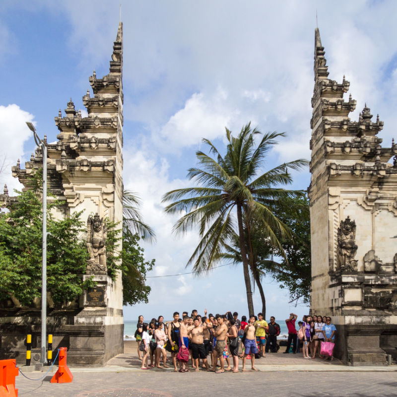 Group Of Chinese Tourists Stand At Kuta Beach Gate in Bali