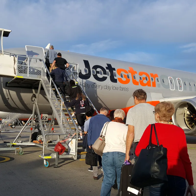 Passengers and Travelers Board Jetstar Plane