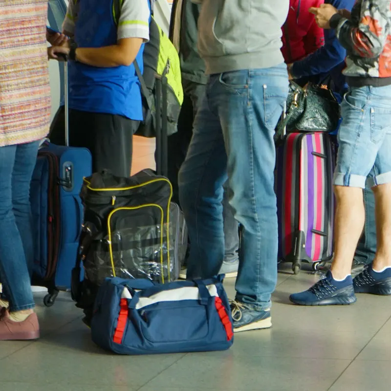 People Stand In Airport Queue.jpg