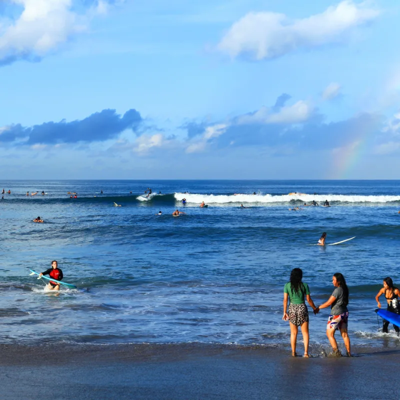 People-Surf-And-Swim-At-Batu-Bolong-Beach-In-Bali