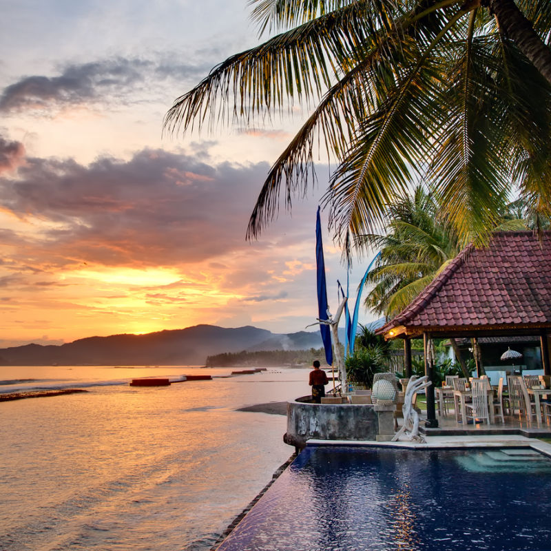 Sunset At Bali Restaurant Resort next To Swimming Pool And beach