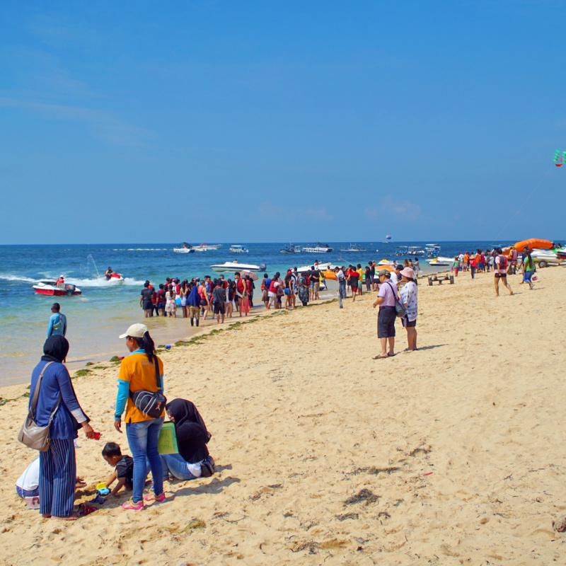 Tourists Enjoy Tanjung Benoa Beach in Bali.jpg