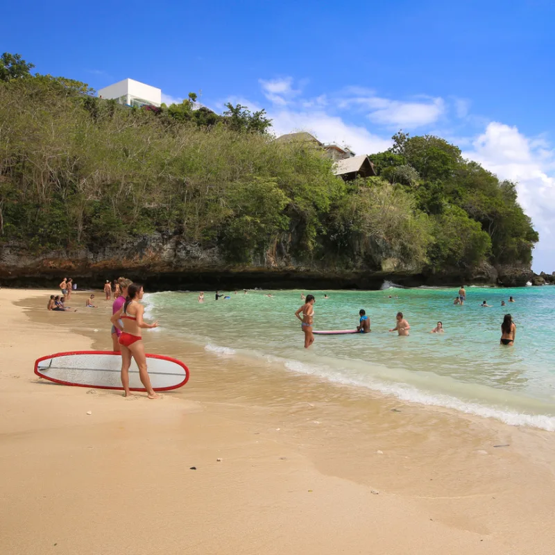 Tourists Play On Padang Padang beach in Bali