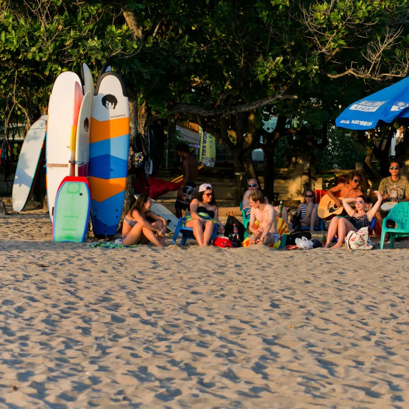 Tourists Relax On Kuta Beach In Bali
