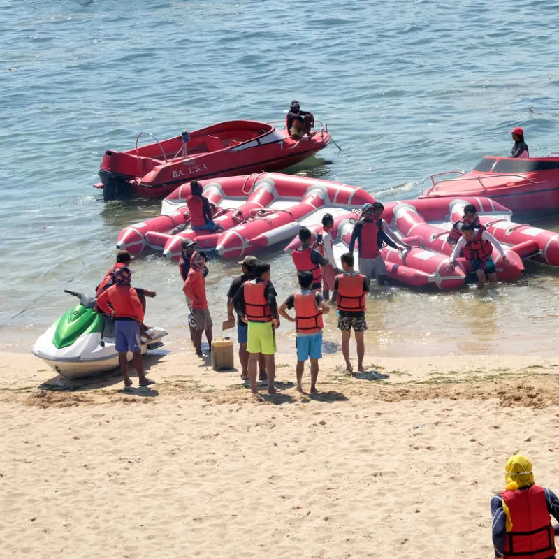 Tourists Wait To Board Banana Boats At Tanjung Benoa Beach In Bali