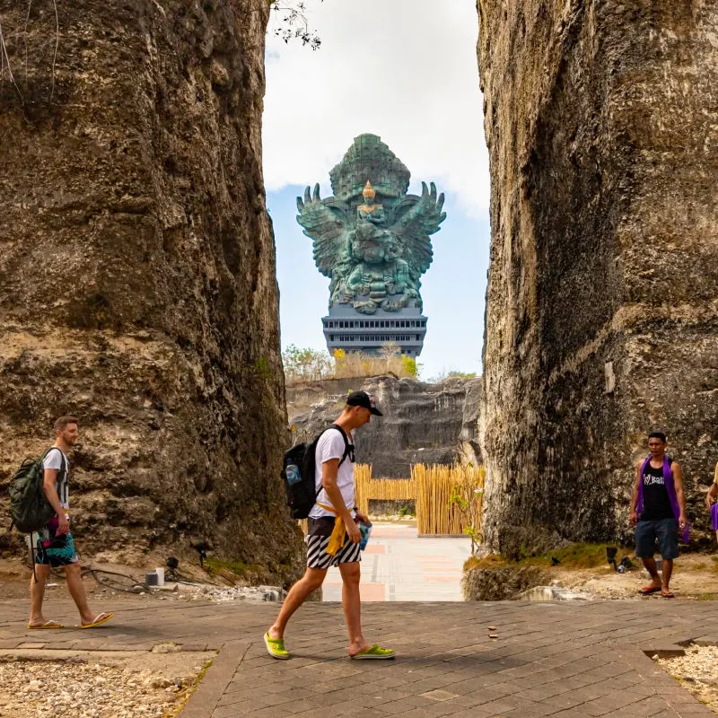 Tourists Walk Out GWK Statue At Bali Cultural Park