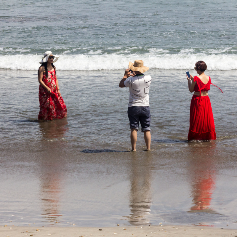 Chinese Tourists Take photos On Beach in Bali