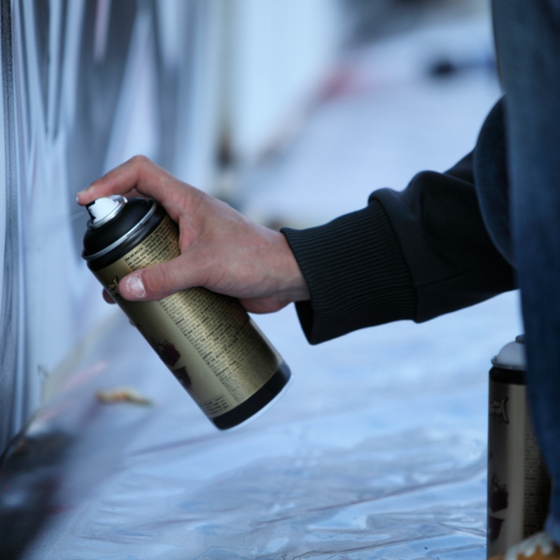Close Up Of Hand On Spray Can Painting Graffiti