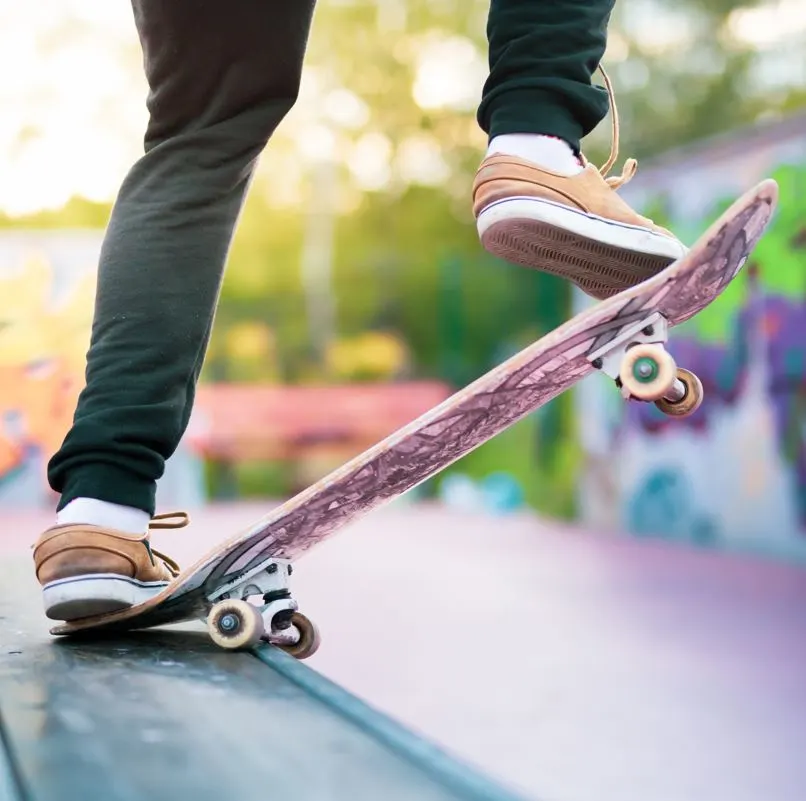 Person standing on a skateboard at a skate park