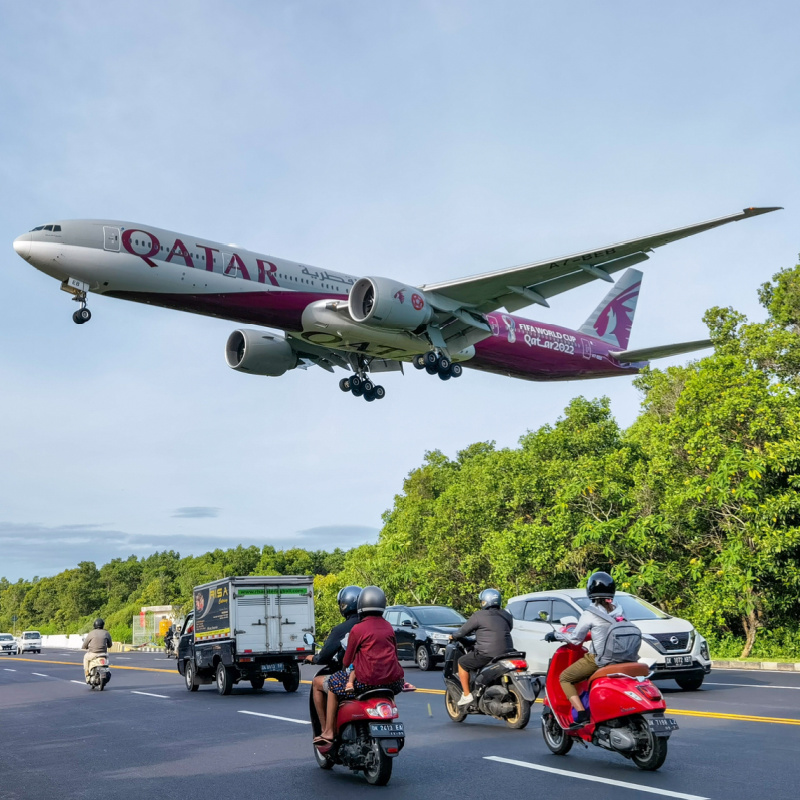 Qatar-Airways-Plane-Flies-Over-Bali-Road