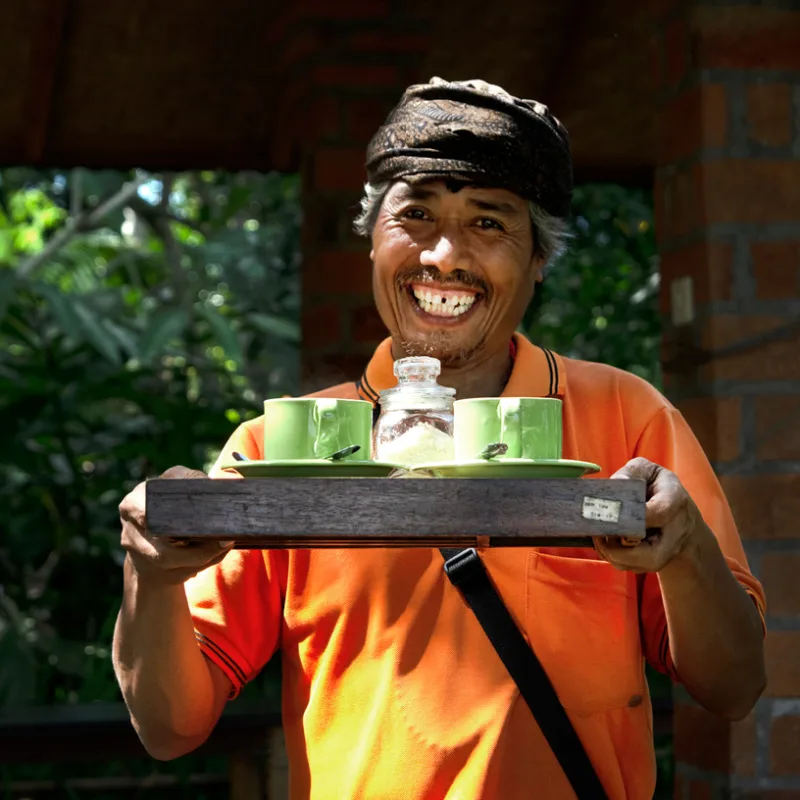 Bali Tourism Worker Staff Brings Coffee On Tray.jpg