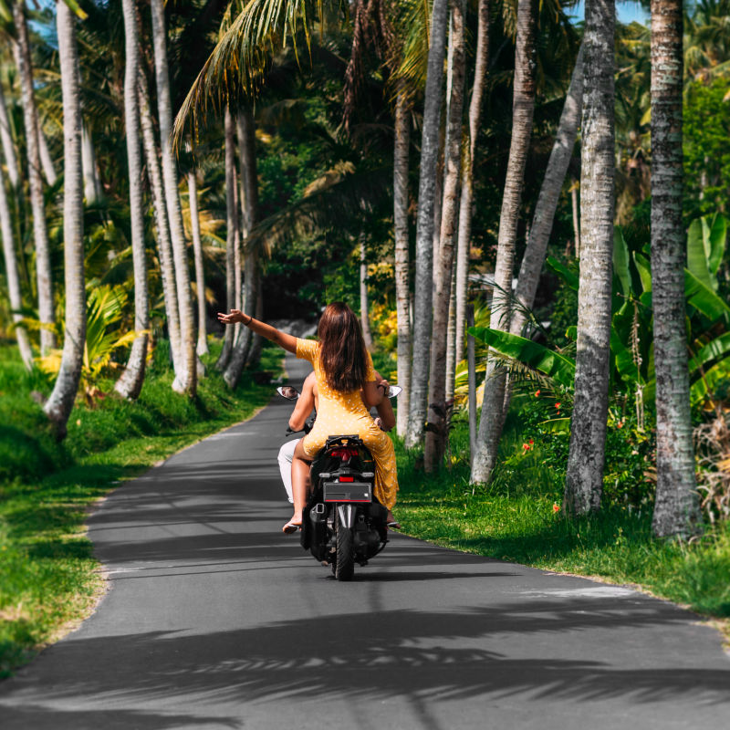 Tourists Drive Moped In Quiet Road in Bali