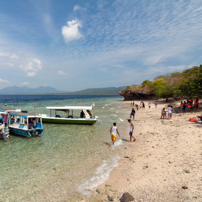 Tourists Enjoy Beach in West Bali National Park Menjagan island.