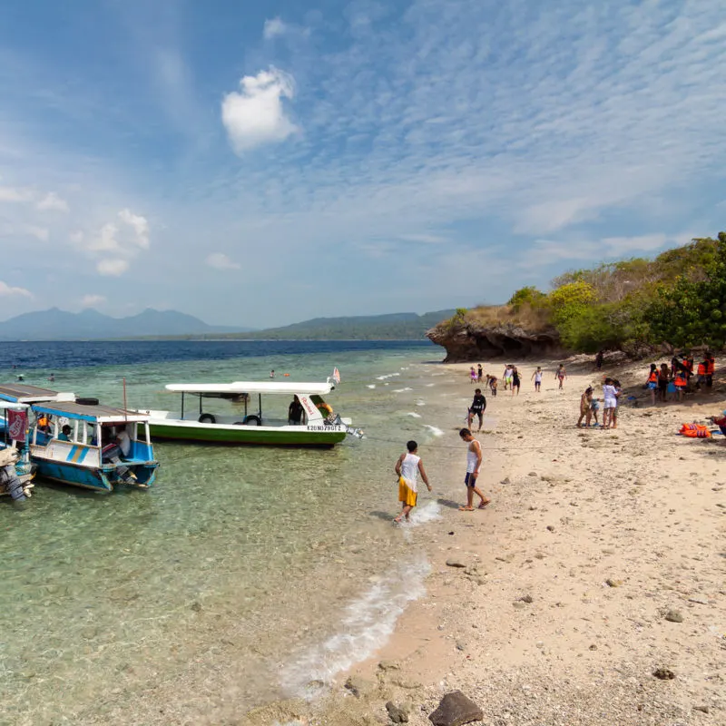 Tourists Enjoy Beach in West Bali National Park Menjagan island.