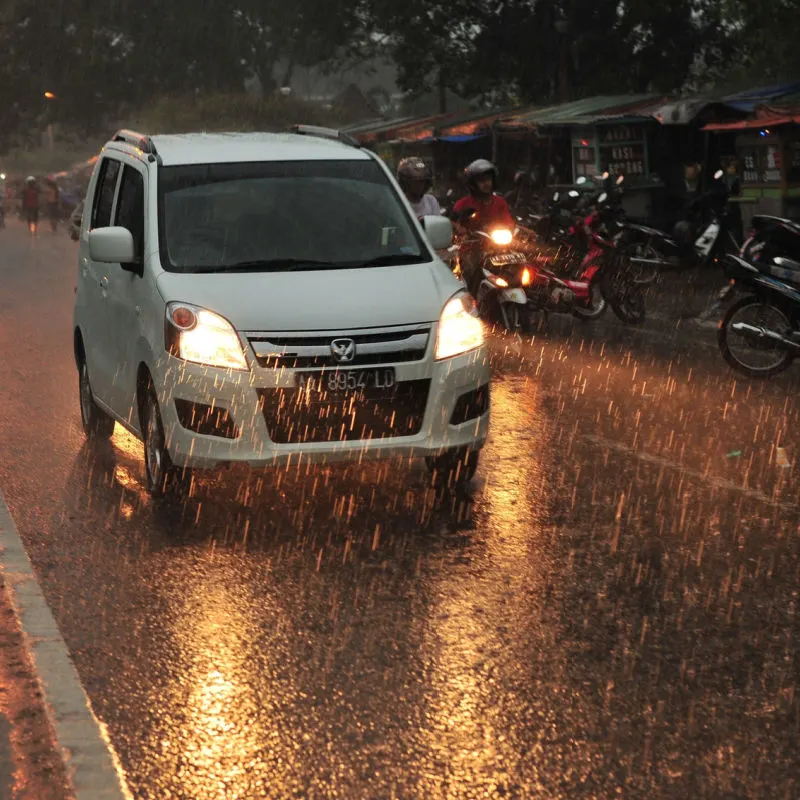 White-Car-Drives-Through-Storm-Rain-in-Bali