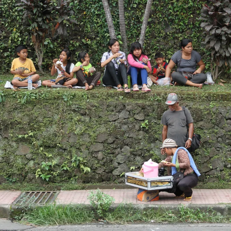 Young Family in Bali Walk Towards Temple