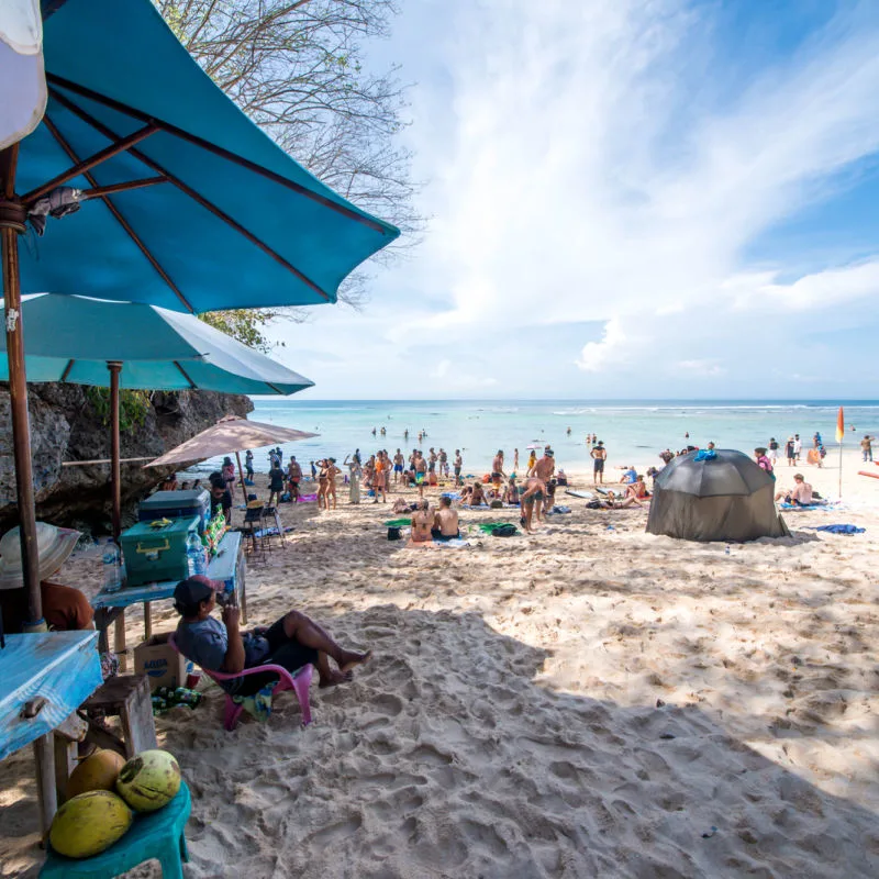 A popular beach in Bali crowded with tourists