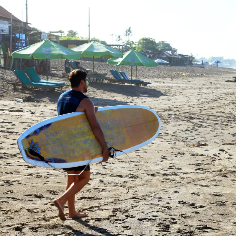 man holding surf board