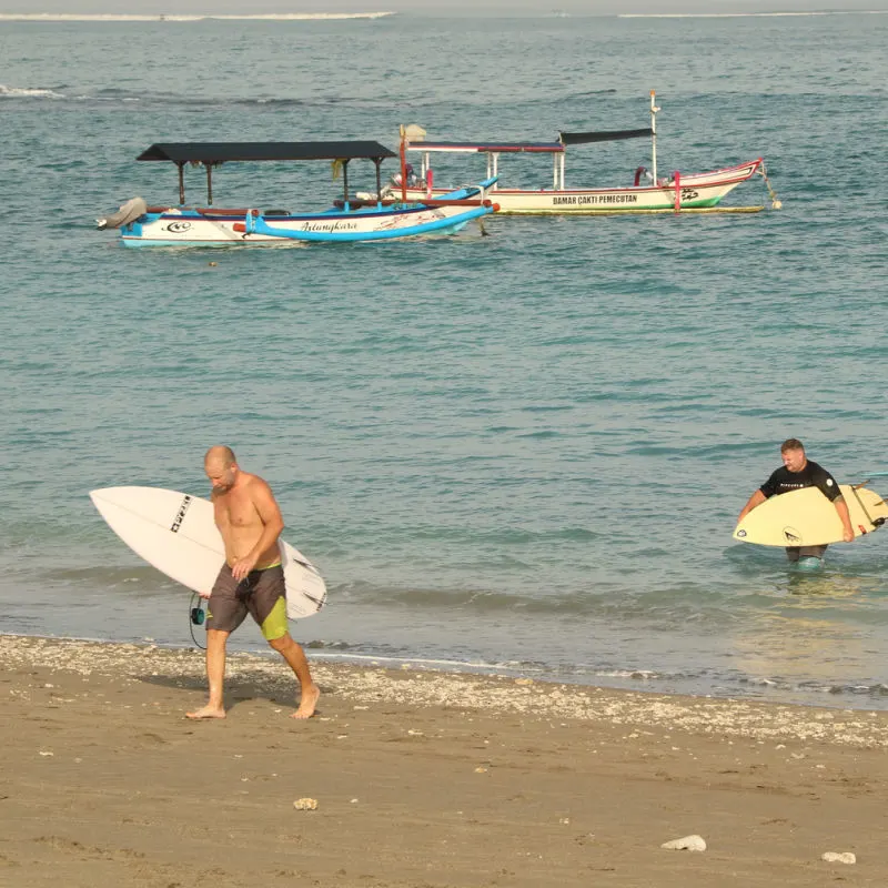 Surfers Leave Water At Panati Jerman Bali