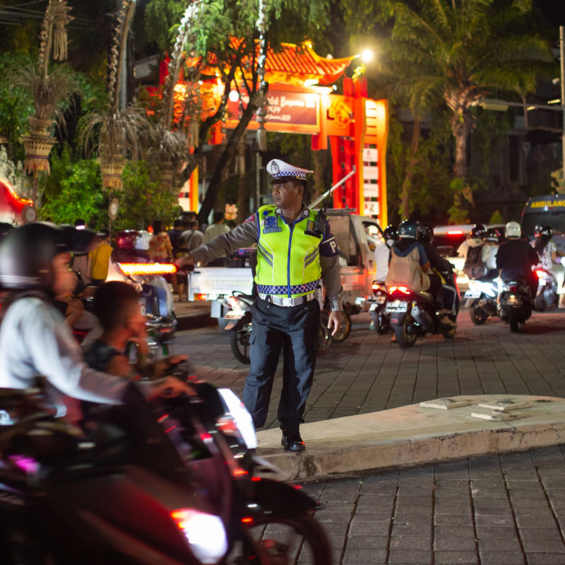 Traffic Officer Police Directs Drivers on Denpasar Bali