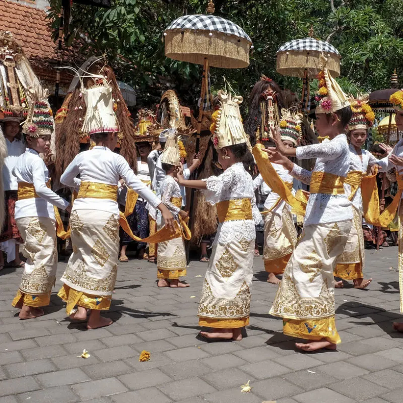 Women in Bali perform traditional ceremony dance.