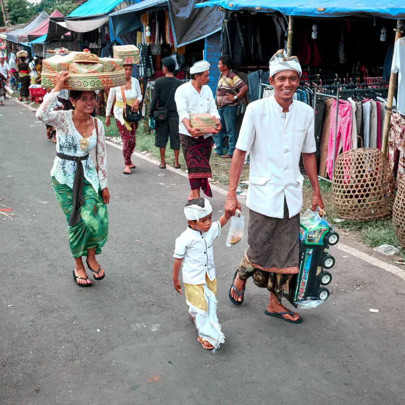 Young Family in Bali Walk Towards Temple