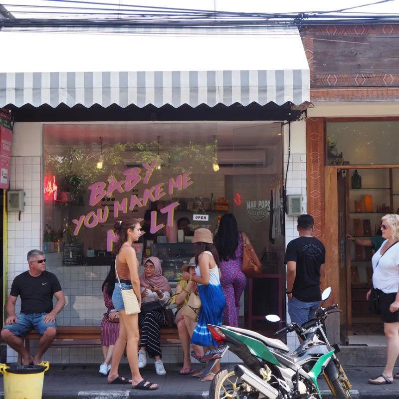 Tourists-Walk-Down-Street-In-Bali