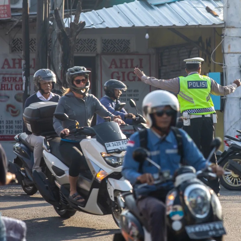 Traffic policeman on the street in Canggu Bali mopeds