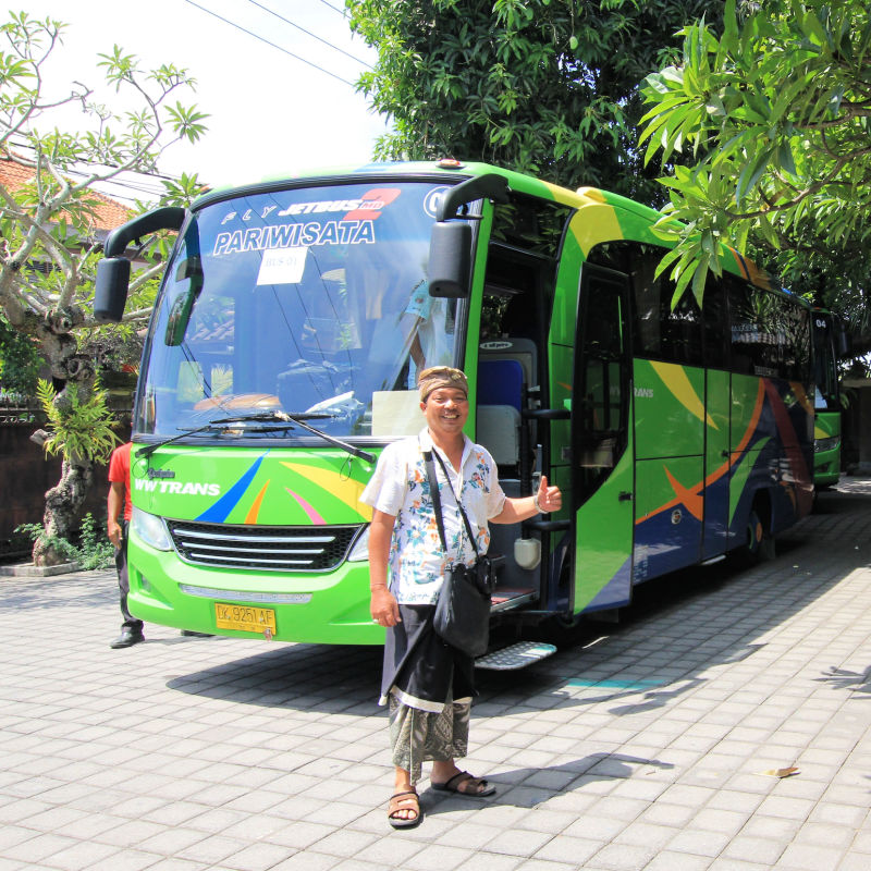 Tour Guide Stands Next To Tourist Bus in Bali.jpg