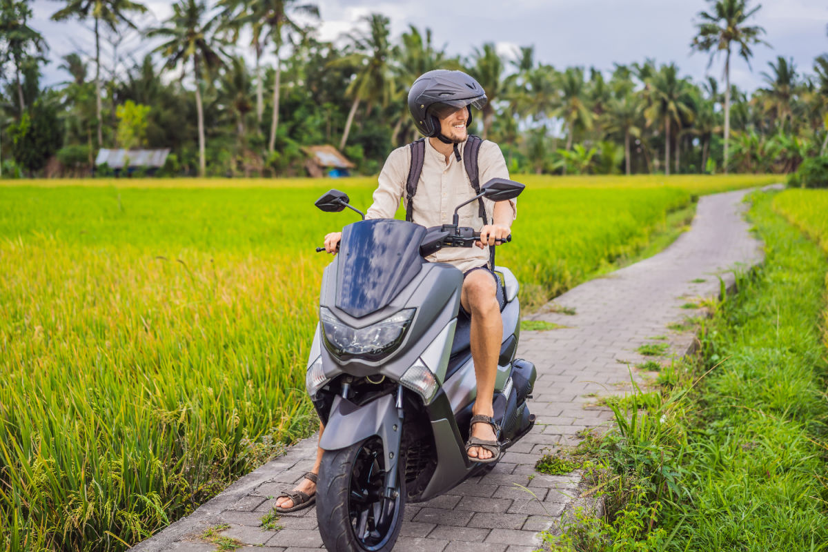 Tourist on Moped in Rice Paddie Farm Track in Bali.jpg