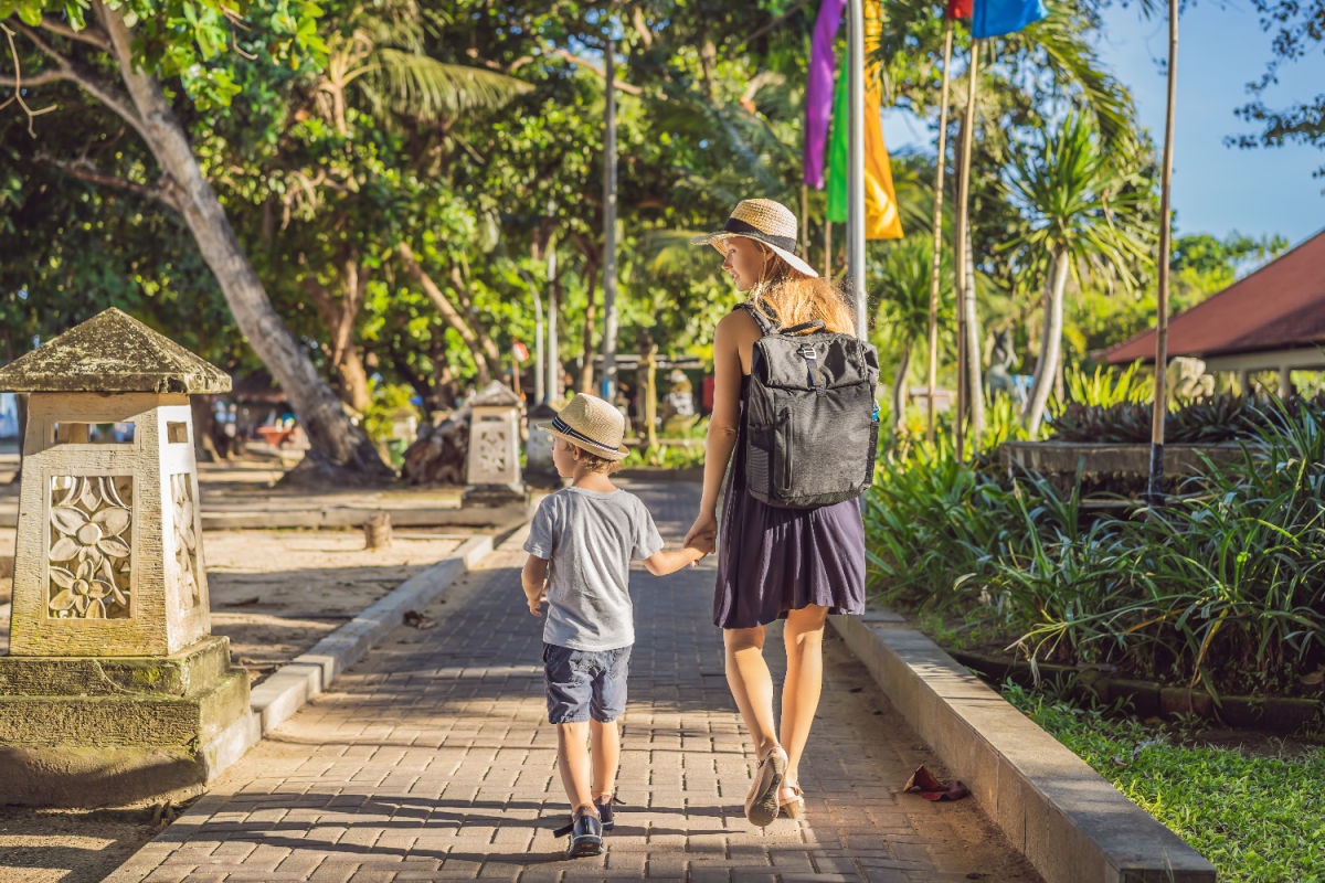 Mother and Son Walk Along Beachwalk Path at Sanur Beach Resort in Bali.jpg