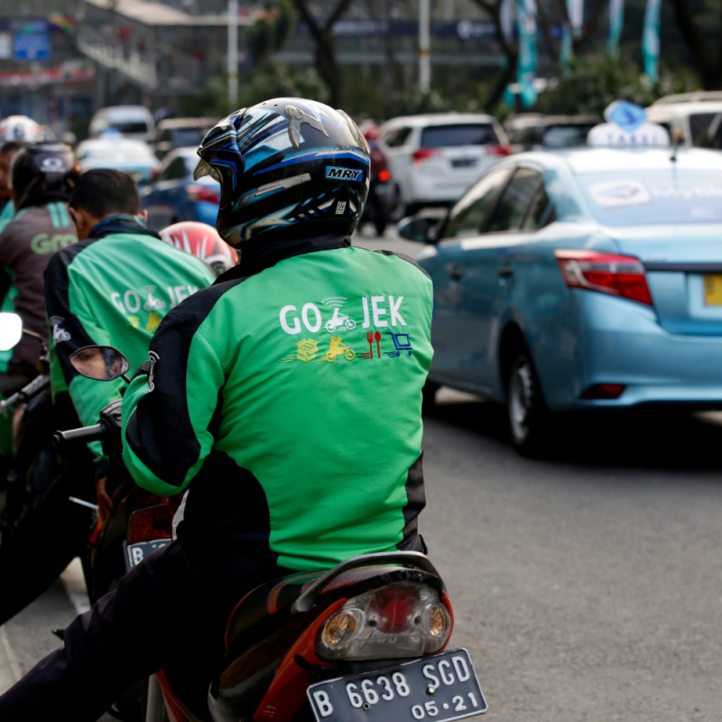 GoJek-and-Grab-Motorcycle-Taxi-Drovers-Line-Up-In-Traffic-Queue
