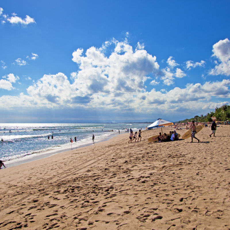 Kuta Beach in the Day Time Tourists Sunbathing in Bali.jpg