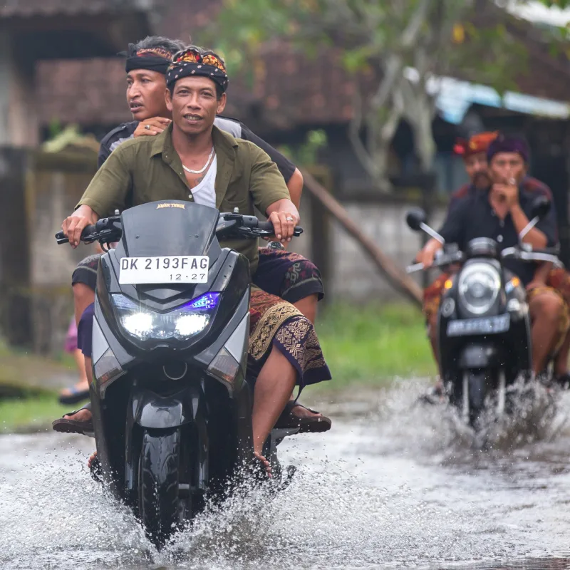 Men-on-Moped-Drive-in-Flood-Rain