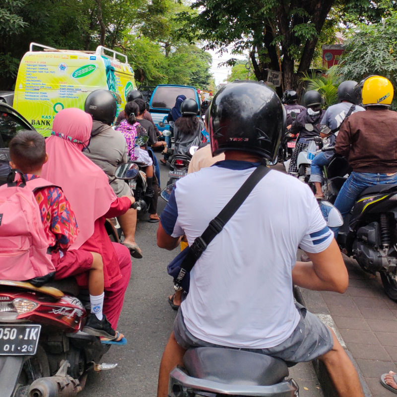 Moped-Drivers-sit-In-Traffic-Jam-On-Bali-Road-in-Daytime