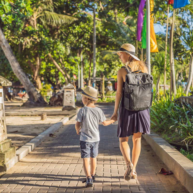 Mother-and-Son-Walk-Along-Beachwalk-Path-at-Sanur-Beach-Resort-in-Bali