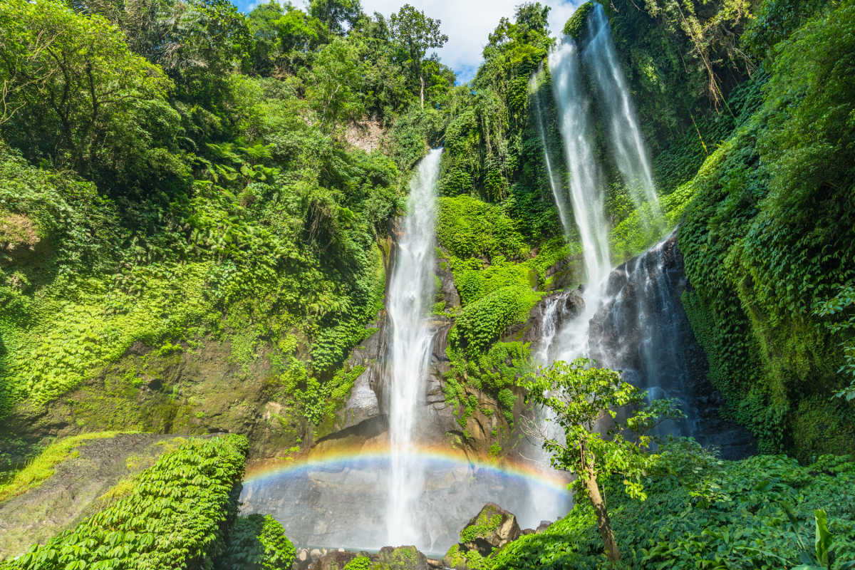 Sekumpul Waterfall in Buleleng Regency in Bali jungle waterfall with rainbow.
