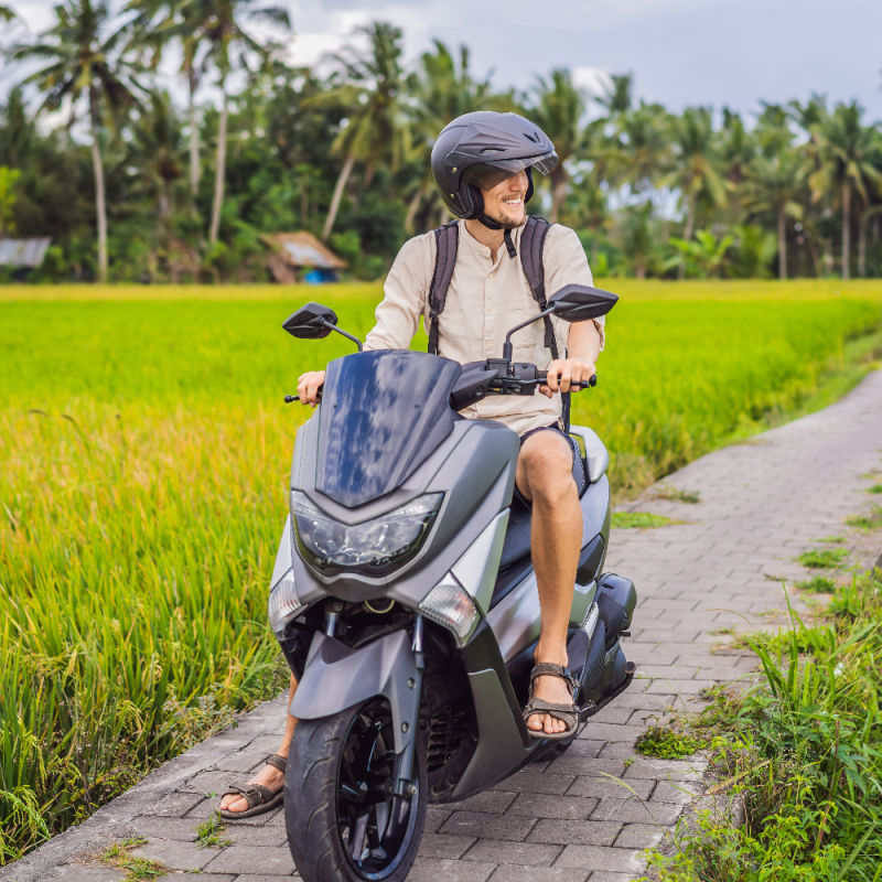 Tourist-on-Moped-in-Rice-Paddie-Farm-Track-in-Bali