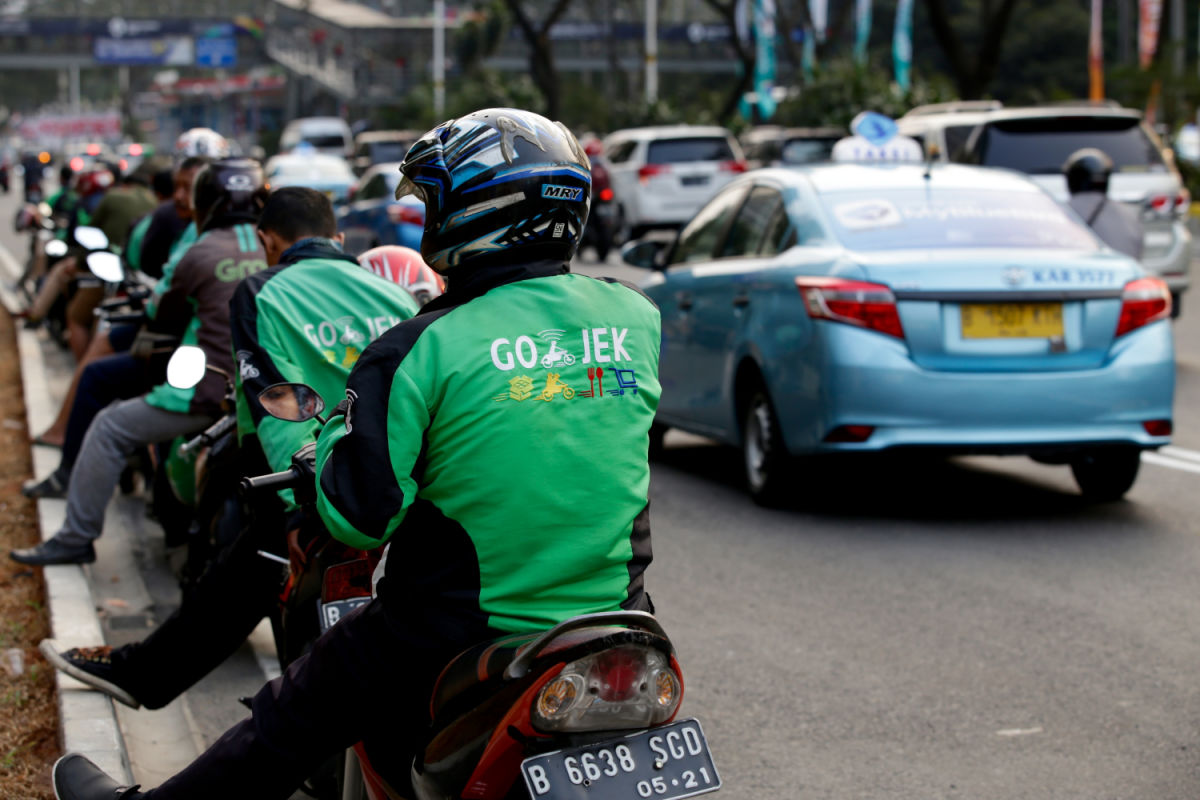 GoJek and Grab Motorcycle Taxi Drovers Line Up In Traffic Queue.jpg