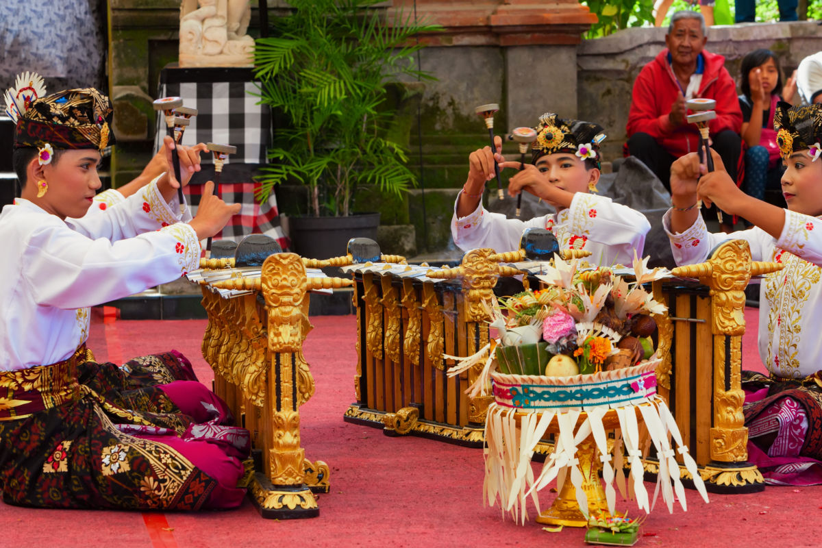Young boys play rindik in the balinese orchestra gamelan at festival.jpg